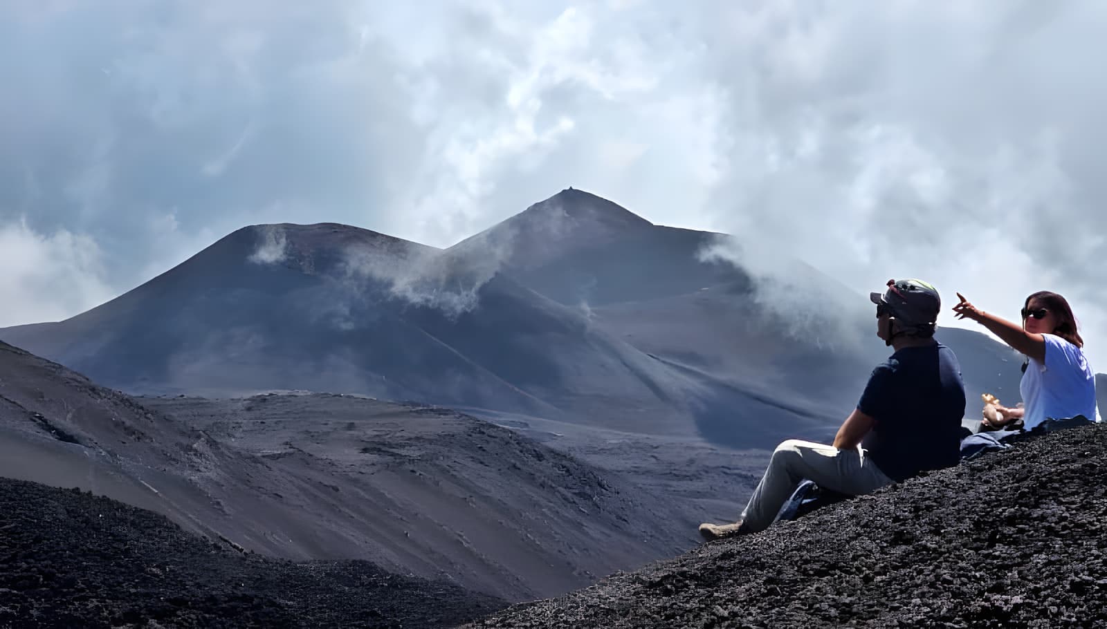 Private group with their guide overlooking Etna's craters